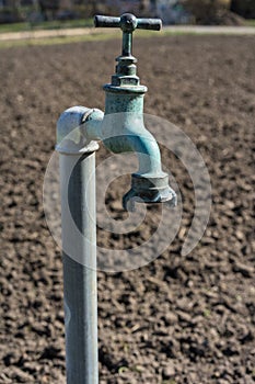 Old water pipe, Faucet with nature brown earth background A old rusty water tap in garden.