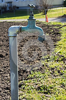 Old water pipe, Faucet with nature brown earth background A old rusty water tap in garden.