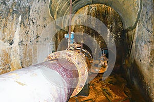 Old Water pipes in underground tunnel in rural Kenya