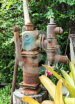 Old water pump ,vintage decoration in the local cafe at Lampang province, northern of Thailand.