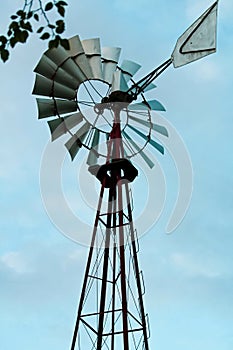 Old water pump windmill in a farm