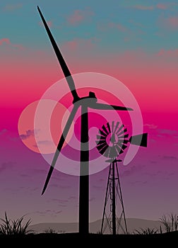 An old water pumping windmill stands in contrast to the giant energy producing wind turbine