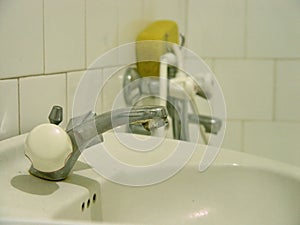 Old water spigot, sink in bathroom
