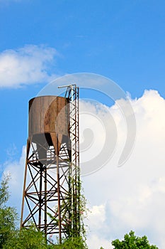 Old water tank tower on blue sky