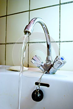 Old water tap with running water