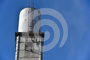 Old water tower against the blue sky