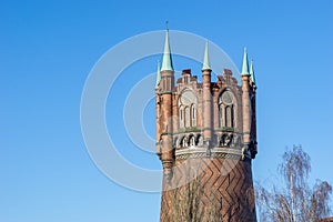 Old water tower with blue sky in the background