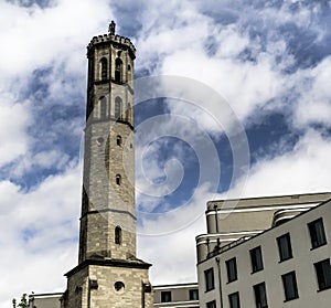 Old water tower in Braunschweig with the modern new building of a new hotel in the foreground