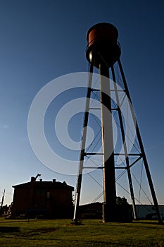 Old water tower and school building silhouetted