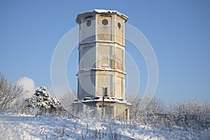 Old water tower in winter landscape. Gatchina