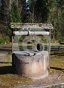 Old water well with bucket.