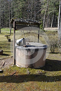 Old water well with bucket.