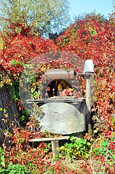 Old water well with pulley and bucket