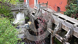 Old water wheel construction with modern technology, connected to a turbine