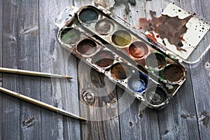 Old watercolor paints and brushes