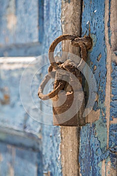 Old waterfront house shutter and padlock Mykonos Town Greece photo