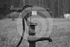 Old waterpump near a cabin photo