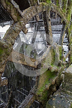 Old waterwheel on river Sorgue in old town Lisle-sul-la-Sorgue in Provence, France, traditional French watermill