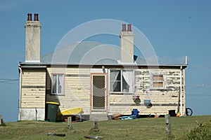 An old weatherboard house, against a blue sky. photo