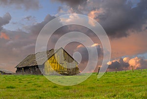 Old weathered abandoned barn in a field