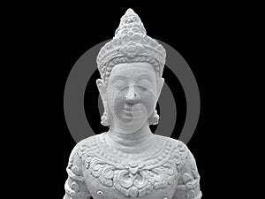 An old weathered Asian Buddhism statue isolated on black background.