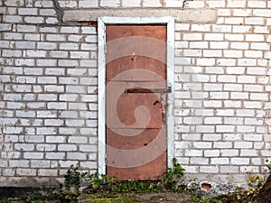 Old weathered barn door and brick wall.