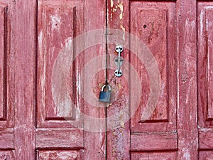 Old weathered barn doorwith with padlock