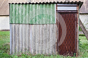 Old weathered barn with metal door.