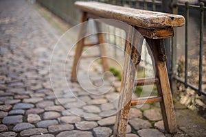 Old weathered bench on street