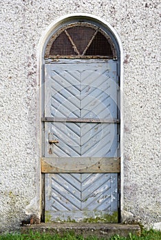 An old weathered blue wooden door