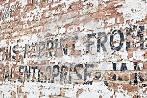 Old Weathered Brick Wall with Advertisement
