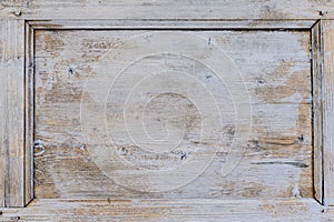 Old weathered brown door with cracked white paint background texture