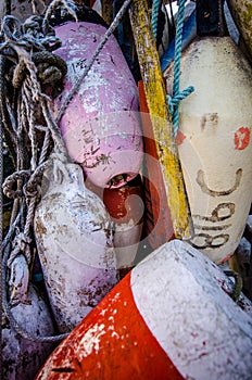 Old weathered bouys attached to a wooden shed on Cape Cod