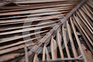 Old weathered coconut leaf roof of hut. Dried banana palm leaves background. Dried palm leaves texture. Close up organic gray palm