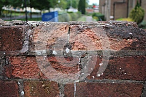 Old weathered crumbling brick wall