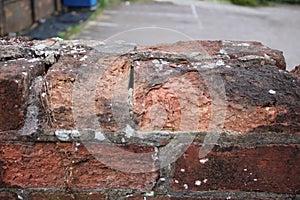 Old weathered crumbling brick wall