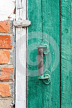 Old weathered door with knob.