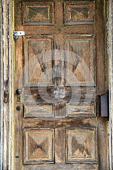 Old weathered door with padlock