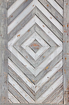 Old weathered door with rhombig decoration