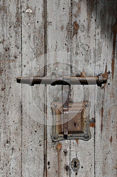 Old weathered door with rusty doorlock