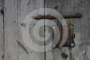 Old weathered door with rusty doorlock