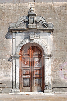 Old weathered door of a small greek church