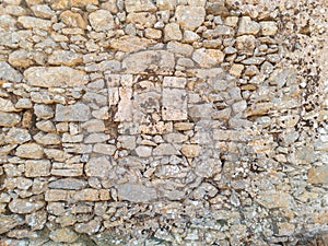 Old weathered exterior rough strong stone wall