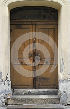 Old weathered, grunge and damaged wooden house entrance door