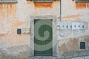 Old weathered grunge house. Green wooden door