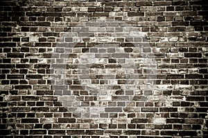 Old and weathered grungy black dark gray concrete block brick wall surface texture dark background