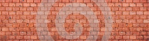 Old and weathered grungy red brick wall texture background in wide panorama format