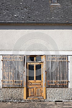 Old weathered, half-decayed and broken yellow painted wooden