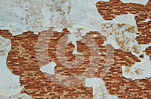 Old weathered plaster on the brick Wall