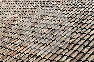 Old weathered red tile roof closeup texture photo
